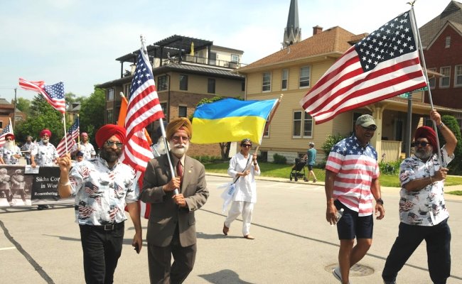 2022_Memorial Day Parade_Naperville IL_Sikhs_Dr. Benny White an US veteran and Naperville village councilman in the parade with Sikhs.jpg